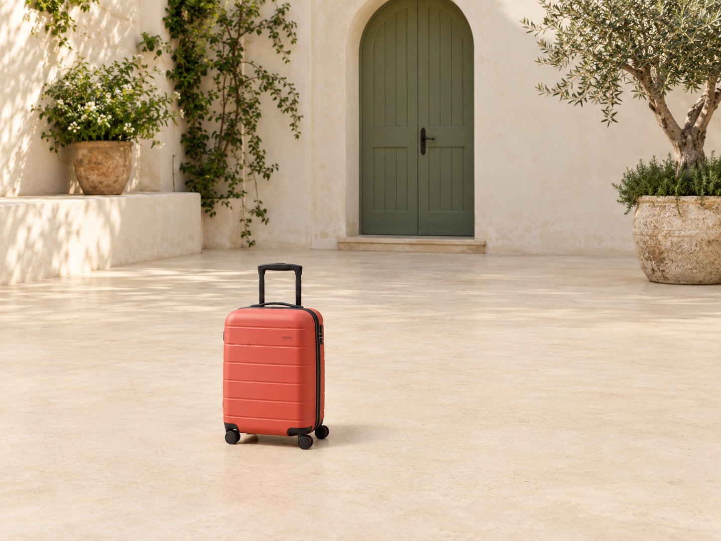 Coral suitcase in a limestone courtyard: original